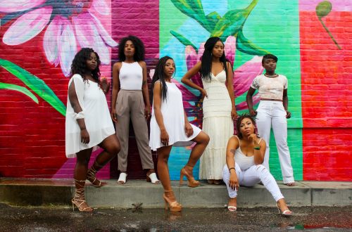 group of models in front of colorful wall