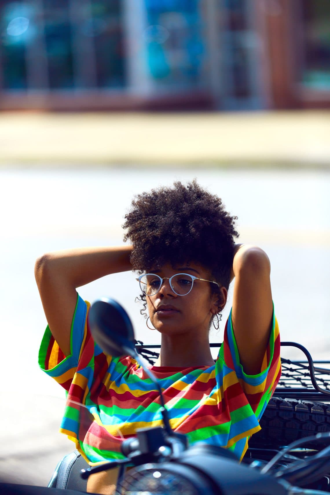 curly haired model wearing striped shirt