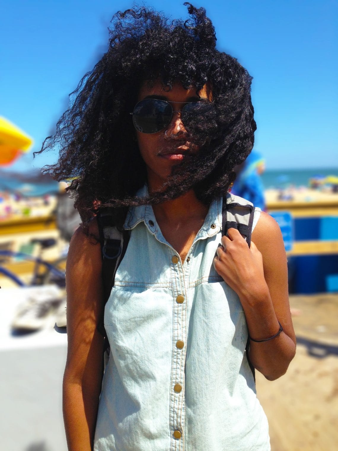 Model wearing sleeveless shirt on the beach